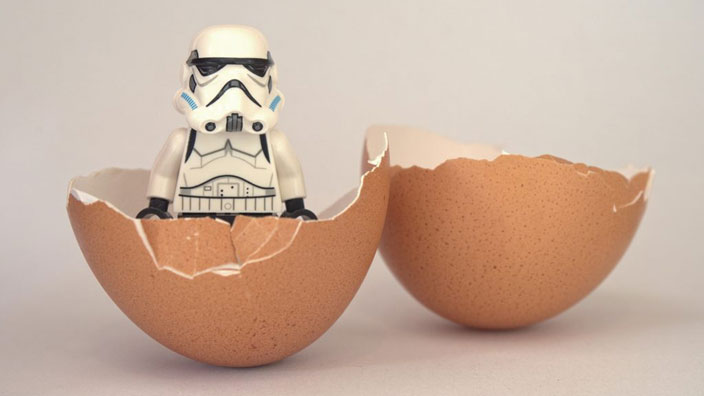 A Star Wars Storm Trooper hatching from a chicken's egg